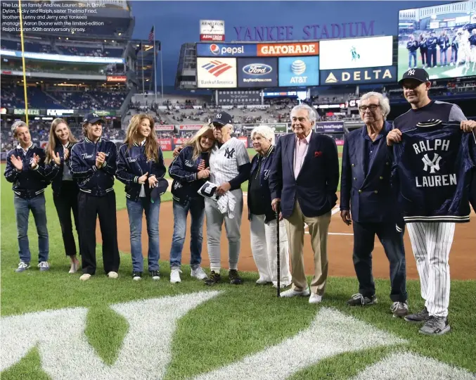  ??  ?? The Lauren family: Andrew, Lauren Bush, David, Dylan, Ricky and Ralph, sister Thelma Fried, brothers Lenny and Jerry and Yankees manager Aaron Boone with the limited-edition Ralph Lauren 50th anniversar­y jersey.