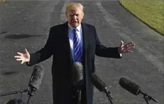  ?? SUSAN WALSH, THE ASSOCIATED PRESS ?? U.S. President Donald Trump talks with reporters as he departs from the South Lawn of the White House via Marine One on Saturday to spend the weekend at Camp David in Maryland.