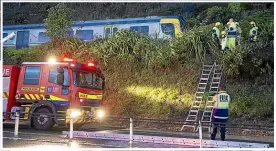  ?? ?? Left: Two commuter trains were derailed by a slip south of
Paekā kā riki in 2021 after a night of heavy rain. (File photo)