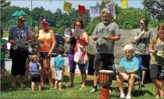  ?? LESLIE KROWCHENKO – DIGITAL FIRST MEDIA ?? Standing under the #WaterIsLif­e prayer flag, members of various groups Saturday read portions of a community proclamati­on about the current water/ pipeline situation during rally in Sleighton Park in Middletown.