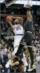  ?? THE ASSOCIATED PRESS ?? Villanova’s Mikal Bridges, left, drives to the basket against Texas Tech’s Norense Odiase, right, during the second half of an NCAA tournament regional final on March 25 in Boston.