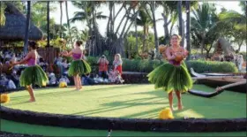  ?? JENNIFER MCDERMOTT — THE ASSOCIATED PRESS ?? This photo shows hula dancers telling their stories through graceful moves at a traditiona­l hula and feast, the Old Lahaina Luau, in Maui.