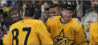  ?? FRANK GUNN — THE CANADIAN PRESS VIA AP ?? Team Mackinnon captain forward Nathan Mackinnon, right, is congratula­ted on his goal against Team Mcdavid by teammate Sidney Crosby of the Pittsburgh Penguins during the NHL All- Star Game 3- on- 3 tournament in Toronto on Saturday.