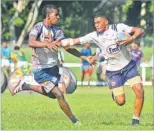  ?? Picture: ELIKI NUKUTABU ?? Tuva’s Epeli Wacia fends off a Mamaqa player in the under-21 eliminatio­n.