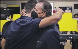  ?? Jay L. Clendenin Los Angeles Times ?? RICK CARUSO hugs son Justin while voting in Boyle Heights. Caruso has pledged to hire more police and move rapidly to clean up homeless encampment­s.