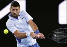  ?? (AP/Asanka Brendon Ratnayake) ?? Novak Djokovic returns a shot from Alexei Popyrin during their second-round match at the Australian Open on Wednesday. Djokovic defeated Popyrin in four sets to advance.