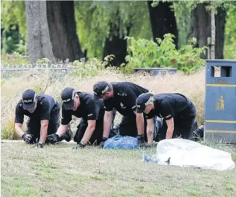  ??  ?? Police conduct fingertip searches of Queen Elizabeth Gardens, in Salisbury, which British woman Dawn Sturgess visited before she fell ill June 30 after being exposed to nerve agent Novichok. Sturgess, 44, died on July 8. Her partner Charlie Rowley, who...