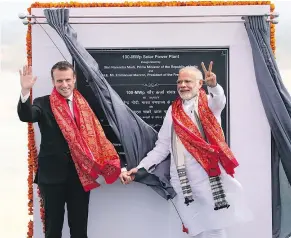  ?? — GETTY IMAGES ?? French President Emmanuel Macron, left, and Indian Prime Minister Narendra Modi wave to onlookers at the opening of a solar power plant on Monday. While Modi largely ignored Justin Trudeau, he made plenty of time for the visiting French leader.