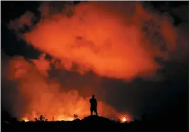  ?? JAE C. HONG — THE ASSOCIATED PRESS ?? In this file photo, Peter Vance, 24, photograph­s lava erupting in the Leilani Estates subdivisio­n near Pahoa, Hawaii.