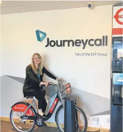  ??  ?? Journeycal­l office manager Keri McGregor tries out one of the bikes and a docking station that found its way to Journeycal­l’s premises in Arbroath.