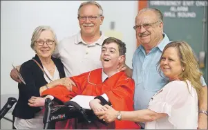  ??  ?? Charlottet­own Rural graduate Brett Robinson is surrounded by family members, from left, grandmothe­r Eleanor Boswell, father David Robinson, grandfathe­r Owen MacRae and mother Lynn Robinson after crossing the stage. The entire audience rose from their...