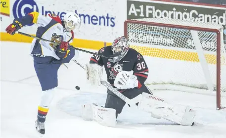  ?? BOB TYMCZYSZYN/POSTMEDIA NETWORK ?? Erie Otters Taylor Raddysh (17) tries to redirect a shot on Niagara IceDogs goalie Stephen Dhillon Sunday in OHL action at Meridian Centre in St. Catharines.
