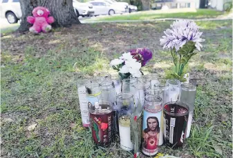  ?? JOHN RAOUX, AP ?? A memorial outside an apartment in Ocala, Florida, on Tuesday where Ajike Owens, a 35-year-old mother of four, was killed by a neighbour in a Friday night shooting.