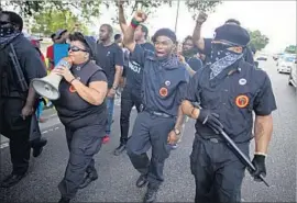  ?? Photograph­s by Max Becherer Associated Press ?? NEW BLACK PANTHER PARTY members march July 9 in Baton Rouge at a demonstrat­ion urging justice for Alton Sterling, who was killed by police.