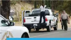  ??  ?? RANCHO TEHAMA RESERVE: A crime scene photograph­er takes photos of a Sheriff’s vehicle that was involved in a shooting in Rancho Tehama, California. — AFP