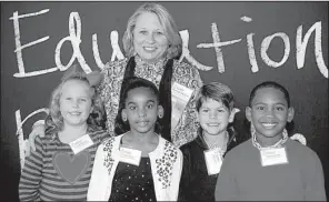  ??  ?? Baker Elementary School teacher Debbie Shearer with first-grade pupils
Gracie Faulkner, Aubre Saine, Matt Marquez and Nehemiah Love