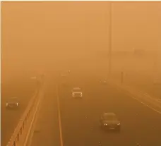  ?? AP; EPA ?? A man walks through a sandstorm in Baghdad on Monday, left. Right, a storm envelops drivers in Kuwait City May