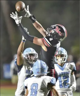  ?? Chris Torres/ The Signal ?? Saugus High defenders Matthew Stirwalt (45), Gage Sheklow (8) and Jadon Lemmons (12) break up a pass to Hart wide receiver Shawn Irwin (4) at College of the Canyons on Friday.