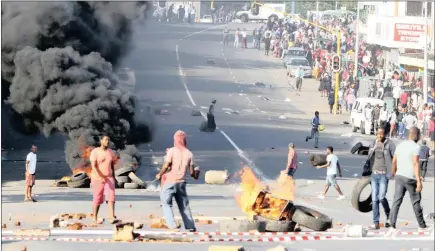 ?? PICTURE: ZULULAND PIX ?? Protesters burn tyres and obstruct the main road in Eshowe yesterday. They are protesting about the state of a road in the area.