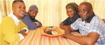  ?? Photos: Sue Maclennan ?? Khuthala Nandipha (left) sits opposite Nokhuselo and Mvuzi Menze, with their son, Ntsika. Her adopted family were still kind and welcoming after all these years. Ntsika, now working as an electricia­n, was a young teenager when Nandipha boarded with...