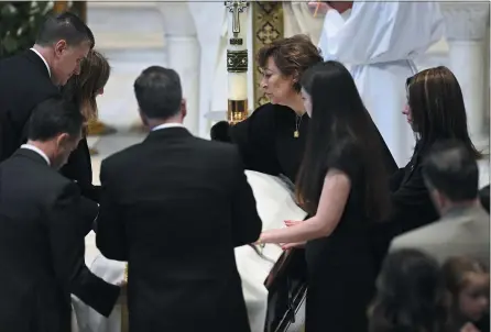  ?? TODD MCINTURF — DETROIT NEWS VIA THE ASSOCIATED PRESS POOL PHOTO ?? Family members, including mother Mary “Mia” Fraser, center right, place a pall on the casket of Brian Fraser as family members, friends and supporters gather during the funeral for Brian Fraser at St Paul on the Lake Catholic Church in Grosse Pointe Farms, Mich., on Saturday.