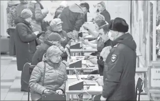  ?? ?? DECIDING: Voters gather at a polling station in Moscow on March 16. Vladimir Putin’s victory makes him the longest-serving Russian leader in 200 years, topping Josef Stalin.