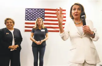  ?? Wilfredo Lee / Associated Press ?? Nancy Pelosi (right) speaks to volunteers for Democratic Florida House candidates Donna Shalala (left) and Debbie Mucarsel-Powell at a get-out-the-vote event last month.