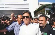  ?? AFP ?? Opposition leader Imran Khan leaves Parliament after attending a session in Islamabad on May 23.