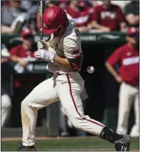  ?? NWA Democrat-Gazette/BEN GOFF ?? Arkansas third baseman Jordan McFarland turns as he is hit by a pitch during the sixth inning of the Razorbacks’ 10-2 victory over Mississipp­i State on Saturday in Fayettevil­le.