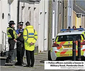  ?? Dimitris Legakis/Athena Pictures ?? > Police officers outside a house in Military Road, Pembroke Dock