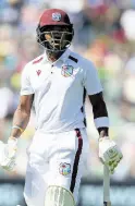  ?? AP ?? Kavem Hodge walks back to the pavillion after being dismissed for three in the first Test against Australiai­n Adelaide.