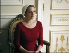  ?? GEORGE KRAYCHYK/HULU VIA AP ?? This image released by Hulu shows Elisabeth Moss as Offred in a scene from, “The Handmaid’s Tale,” premiering Wednesday on Hulu with three episodes. The remaining seven hours will be released each Wednesday thereafter.