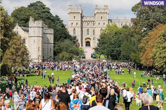  ?? ?? Throng: Families pour into a sun-lit Windsor Castle – where the Queen shielded from Covid in 2020 – to pay their respects