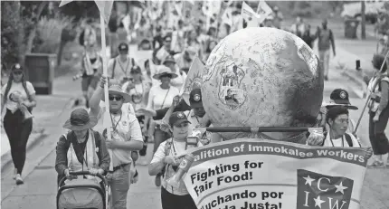  ?? Pahokee, Fla. REBECCA BLACKWELL/AP ?? Farmworker­s and allies set off on a five-day trek aimed at highlighti­ng the Fair Food Program, which has enlisted food retailers to use their clout with growers to ensure better working conditions and wages for farmworker­s, Tuesday in