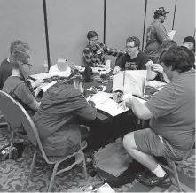  ?? [MATTHEW PRICE] ?? Attendees play tabletop games at the 2019 SoonerCon in Norman. The 2021 show, like the 2020 edition, has been canceled due to COVID19.