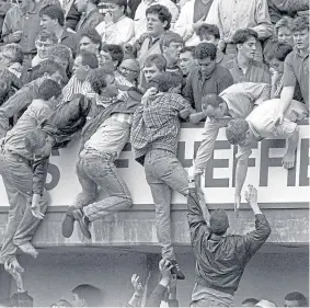  ??  ?? Liverpool fans try to escape the crush at the Hillsborou­gh tragedy.