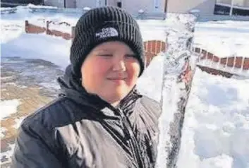  ??  ?? Sharp sight Kian Mcmillan, 11, with an icicle that hung from his family’s caravan in Petersburn
