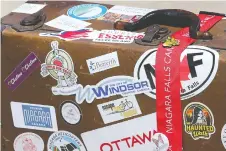  ??  ?? A City of Windsor sticker was placed on a prop suitcase Monday during a news conference about provincial funding to boost tourism, including money earmarked for five local festivals that had to be cancelled.
