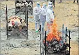  ?? AP ?? Family members wait to perform the last rites of a Covid-19 victim at an open crematoriu­m in Bengaluru on Wednesday.