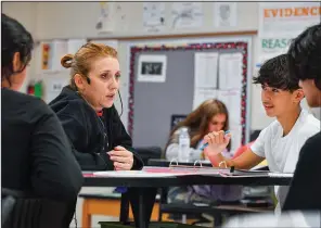  ?? (File Photo/River Valley Democrat-Gazette/Hank Layton) ?? Aimee Brinkley (center), a science teacher at Fort Smith Northside High School, instructs Luis Vidal (right) and other students Sept. 1 inside her classroom in Fort Smith. The School District won’t change staff salaries for the upcoming school year.