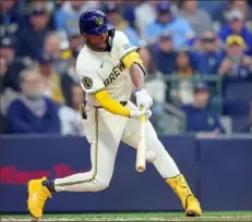  ?? Stacy Revere/Getty Images ?? The Brewers’ Jackson Chourio hits an RBI single during the second inning of the home opener Tuesday against the Twins at American Family Field in Milwaukee.