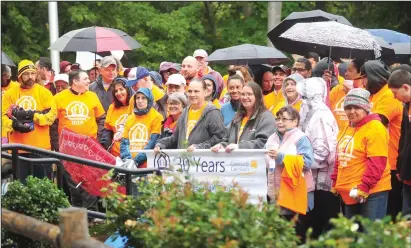  ?? Ernest A. Brown photos ?? Above, participan­ts listen to Woonsocket Mayor Lisa Baldelli-Hunt in the rain at River Island Park before the start of the 30th annual Shelter Walk Saturday. Walkers included former North Smithfield Town Administra­tor Paulette Hamilton, Garrett Mancieri, Woonsocket City Councilor Melissa Murray, Council President Dan Gendron and his family, state Sen. Roger Picard, as well as Woonsocket City Council Vice President Jon Brien and his wife Nicole. Around 75 hardy souls turned out for the walk despite the rain. Below, Laterra Tiller speaks to participan­ts about her hardships and the help she received from Community Care Alliance before taking part in Saturday morning’s Shelter Walk.