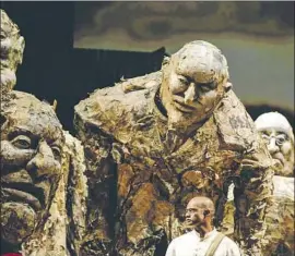  ?? Maria Alejandra Cardona Los Angeles Times ?? GANDHI (Sean Panikkar) is surrounded by puppets of hostile bigwigs incensed by his nonviolent activism, in the Los Angeles Opera production of “Satyagraha.”