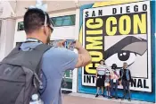  ?? CHRIS PIZZELLO/INVISION ?? Luis Ramos of San Diego takes a picture of family members and their friends at Comic-Con last year at the San Diego Convention Center.