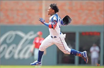  ?? Ap-todd Kirkland ?? Braves center fielder Ronald Acuna Jr. (13) races to second for a double in the first inning against the Cincinnati Reds on Sunday.