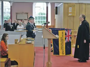  ?? 25_c47remembr­ance10 ?? The Royal British Legion Scotland standards are raised in front of Reverend William Crossan. RBLS chairman Ewan Lang and his wife Tracy are in the first row of pews. Organist was Catrina Macfarlane.