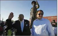  ?? (AP/Rogelio V. Solis) ?? State Sen. David Jordan (left), D-Greenwood and sculptor Matt Glenn acknowledg­e applause as they stand before the statue of Emmett Till on Friday in Greenwood, Miss. Video online at arkansason­line.com/1023till/.