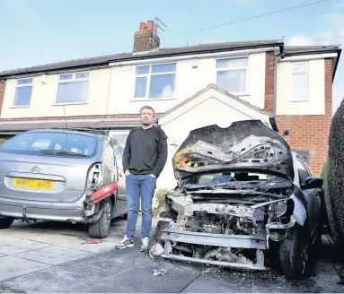  ?? Paul Ponting with the damaged cars after the attack in March last year ??