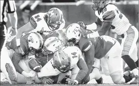  ??  ?? tulane running back Dontrell hilliard (left) loses the ball during the first half of Memphis’ 38-7 victory over the Green Wave on saturday in New orleans. the tigers recovered the loose ball.