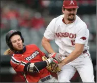  ?? (NWA Democrat-Gazette/Andy Shupe) ?? Connor Noland (right), who entered as a reliever for Arkansas, collides with Southeast Missouri State’s Danny Wright as he tags him out in the sixth inning of Friday’s game.